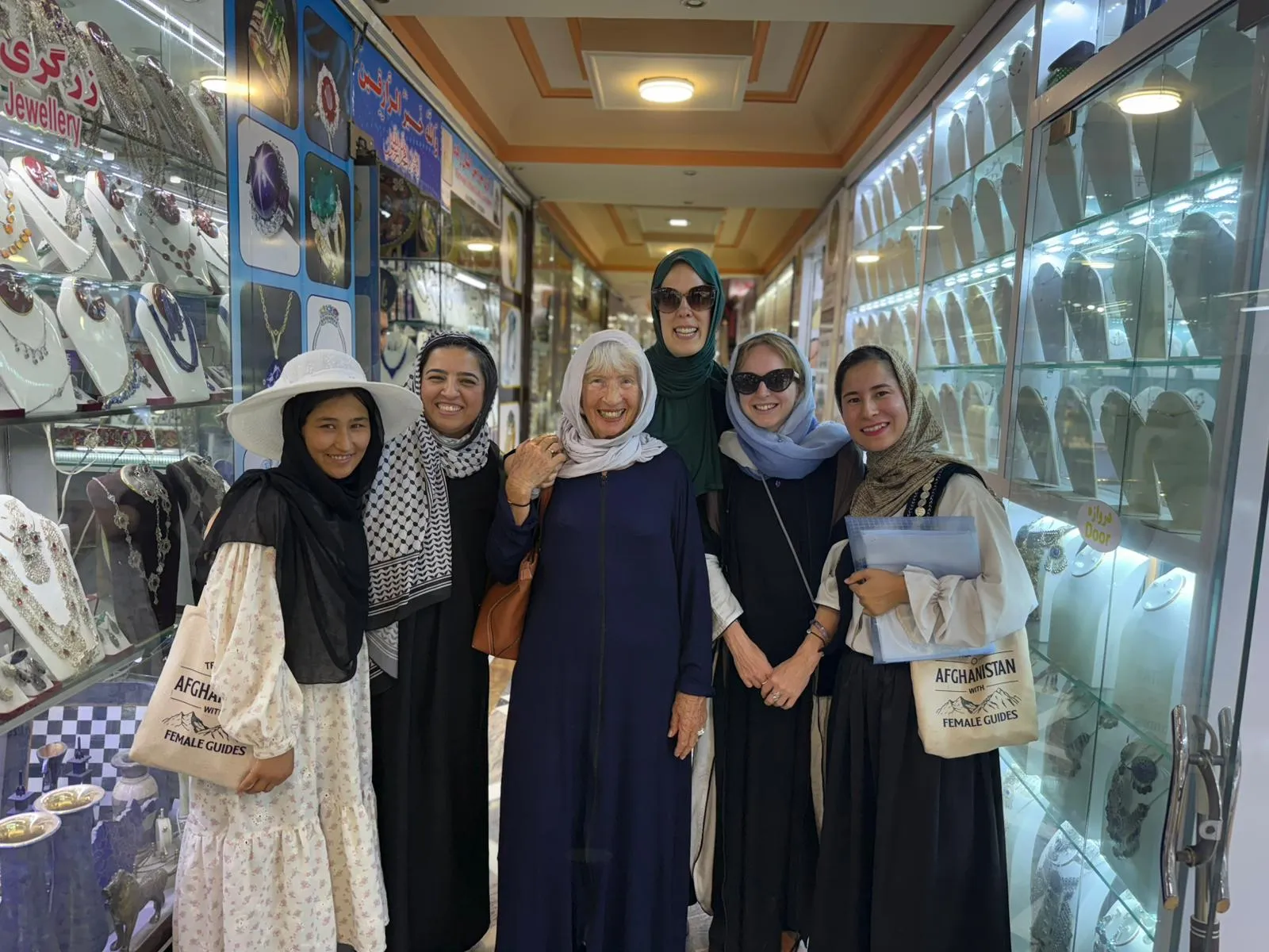 Female travelers exploring Kabul’s antique shops alongside local female tour guides.