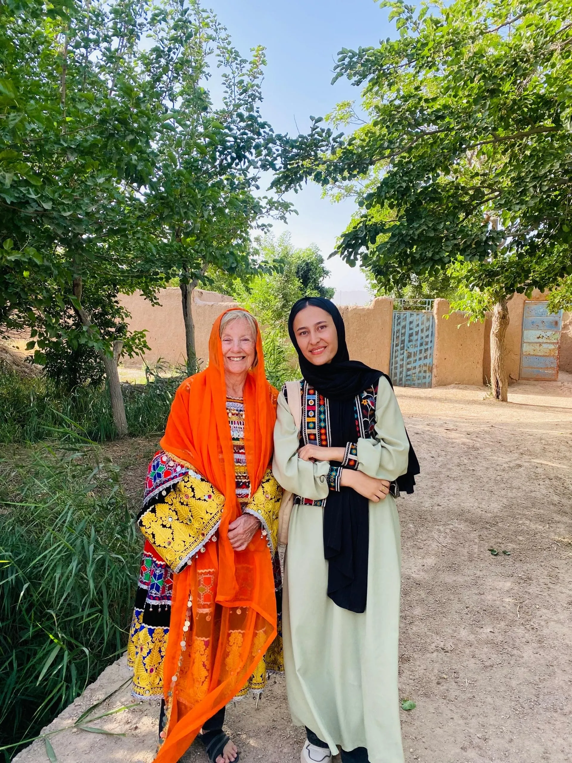 Patricia and our female guide on a village tour in Herat, enjoying traditional Afghan dress experience.