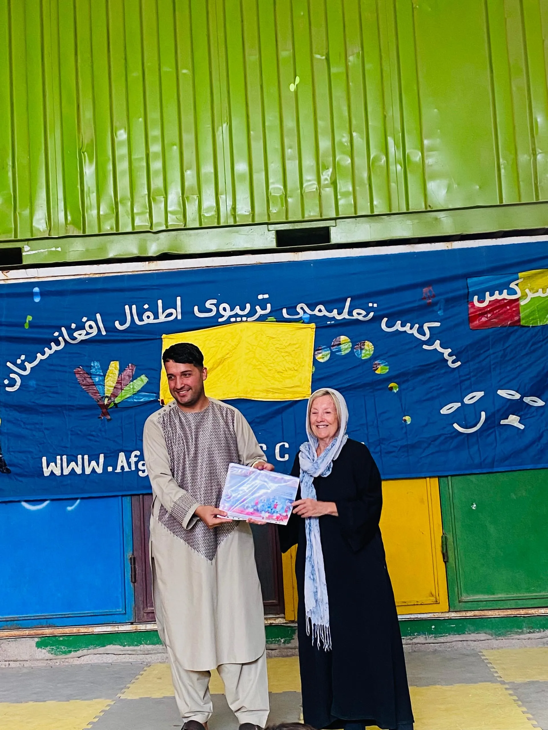 During a visit to the circus in Herat, Patricia presenting certificates to children.