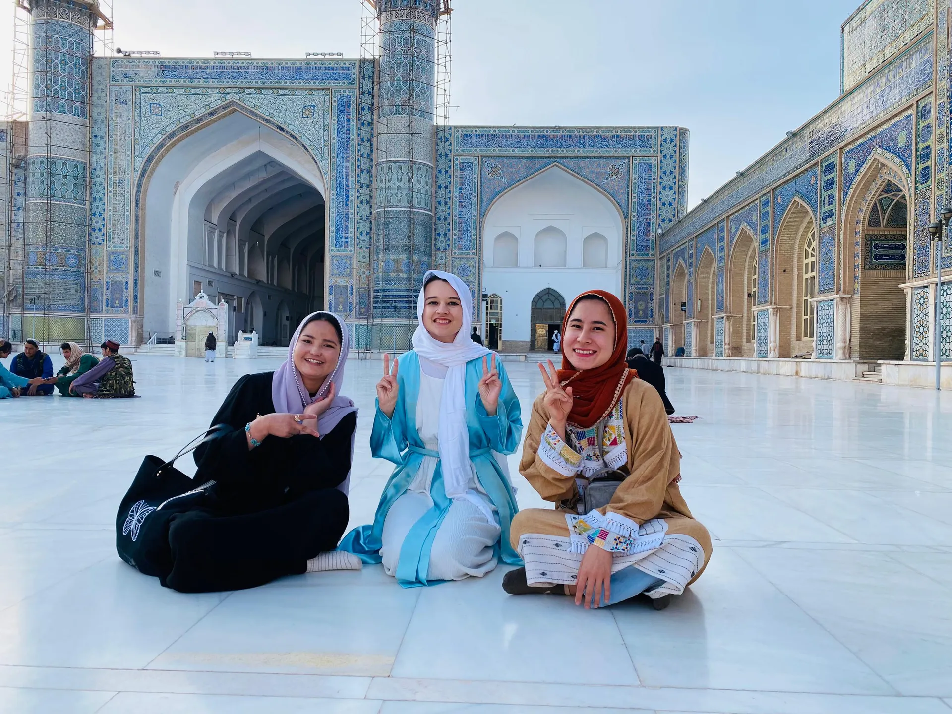 In front of the Blue Mosque of Herat , a beautiful moment with our female traveler and Afghanistan female tour guides, sharing a journey of history, culture, and connection