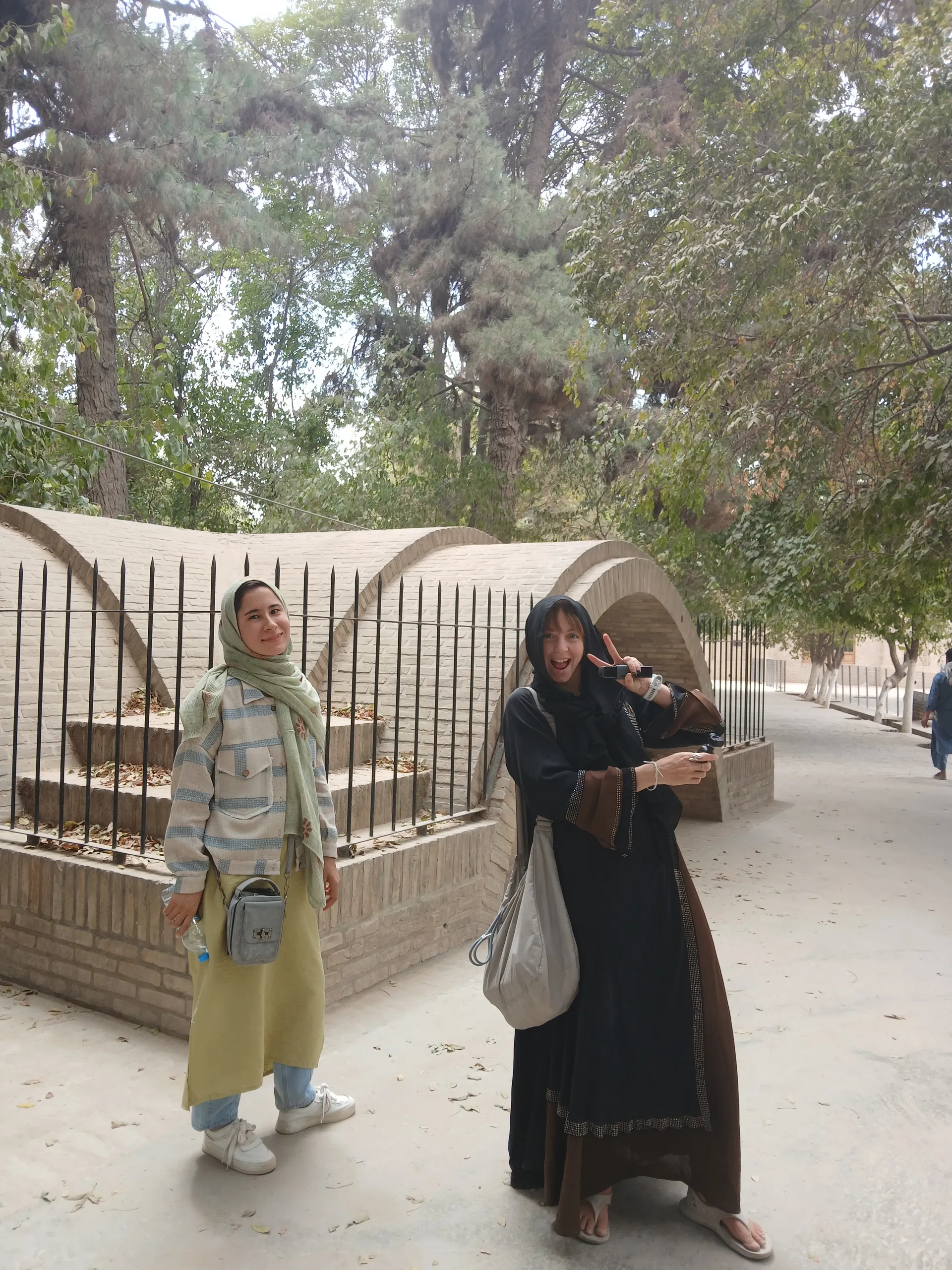 Beside the tomb of Rabia Balkhi in Balkh province — honoring the legacy of one of the first female poets of Persian literature during our research journey.