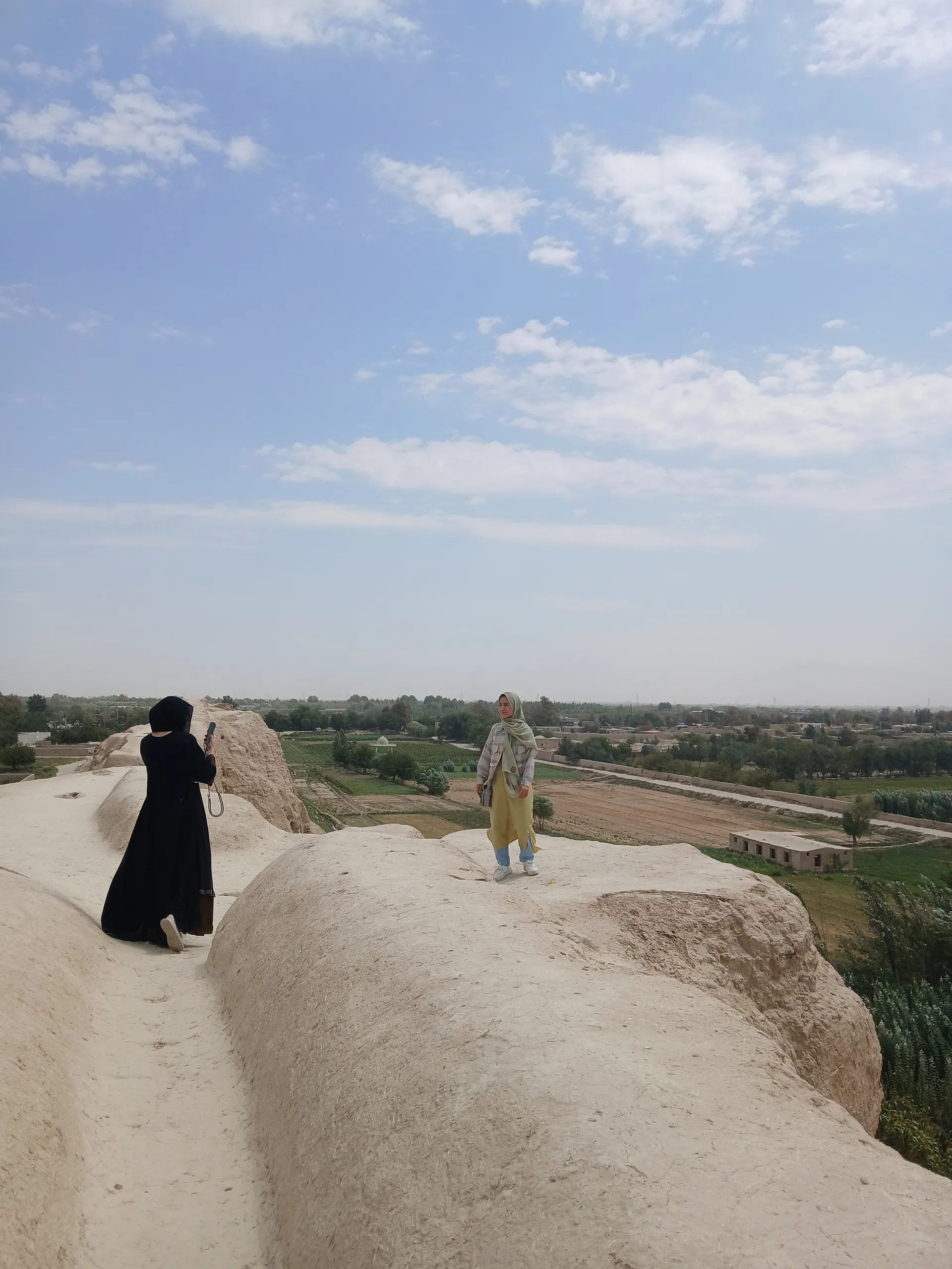 On the ancient walls of Balkh province — walking through centuries of history during our research journey.