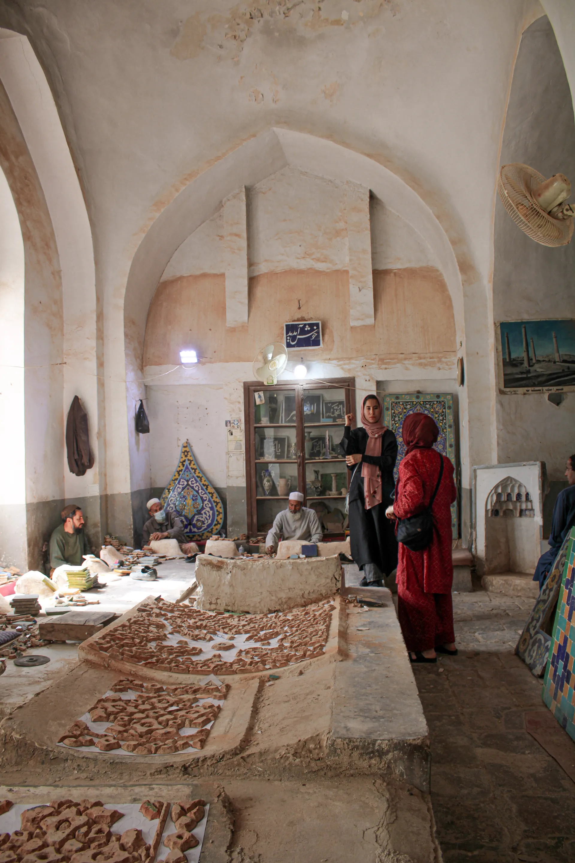 Inside a traditional tile factory in Herat — where our local female tour guide explains the craftsmanship behind the iconic blue tiles of the Blue Mosque, connecting history with living tradition
